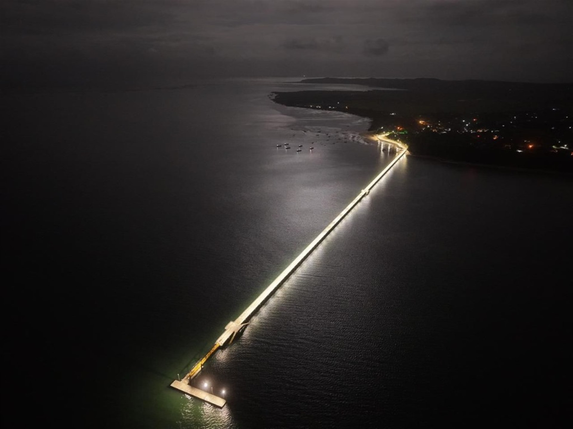 Cais iluminado à noite em Inhaca